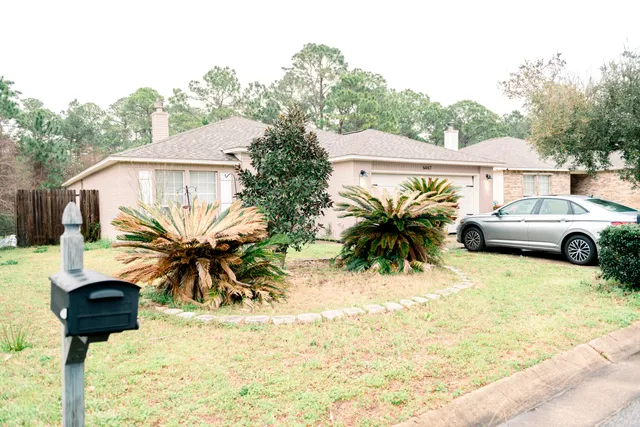 a view of a house with backyard patio and swimming pool