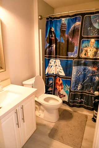 a bathroom with a toilet a sink and a mirror