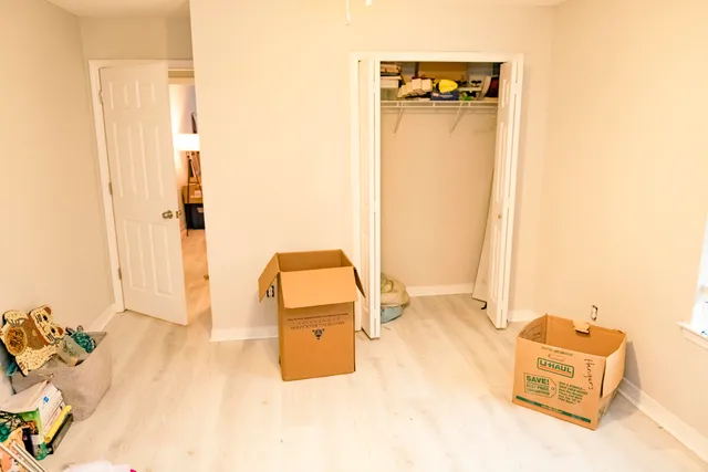 a room with a bed and a dresser