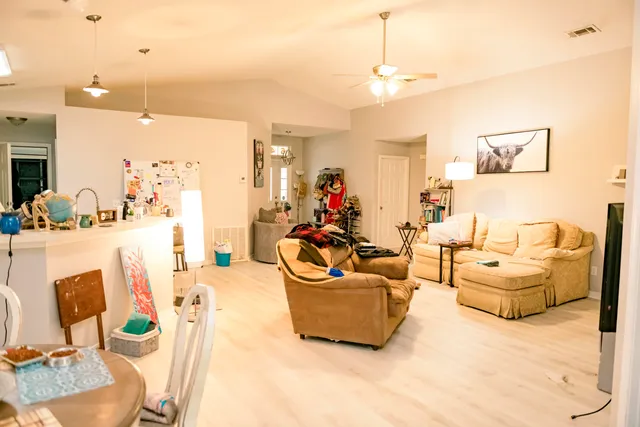 a living room with furniture and a chandelier
