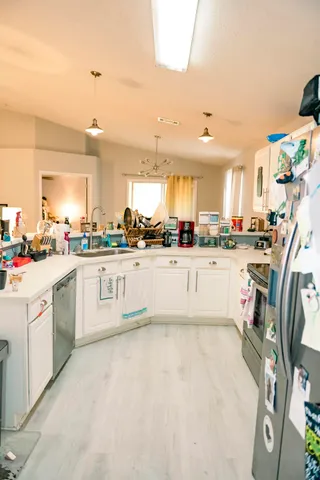 a kitchen with stainless steel appliances kitchen island granite countertop a sink and cabinets