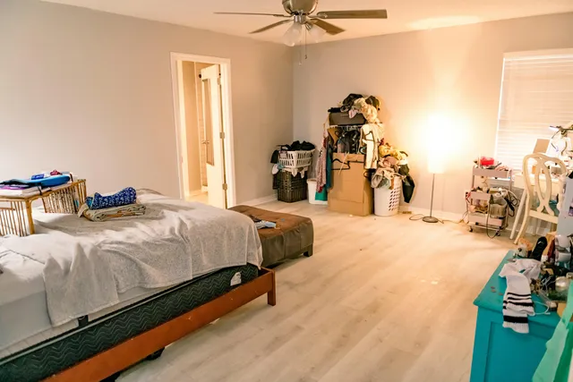 a large bed sitting in a bedroom next to a window