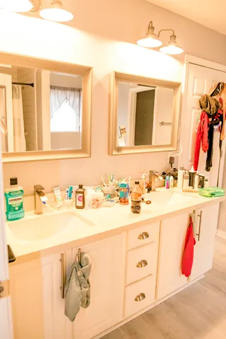 a bathroom with a sink vanity and a mirror
