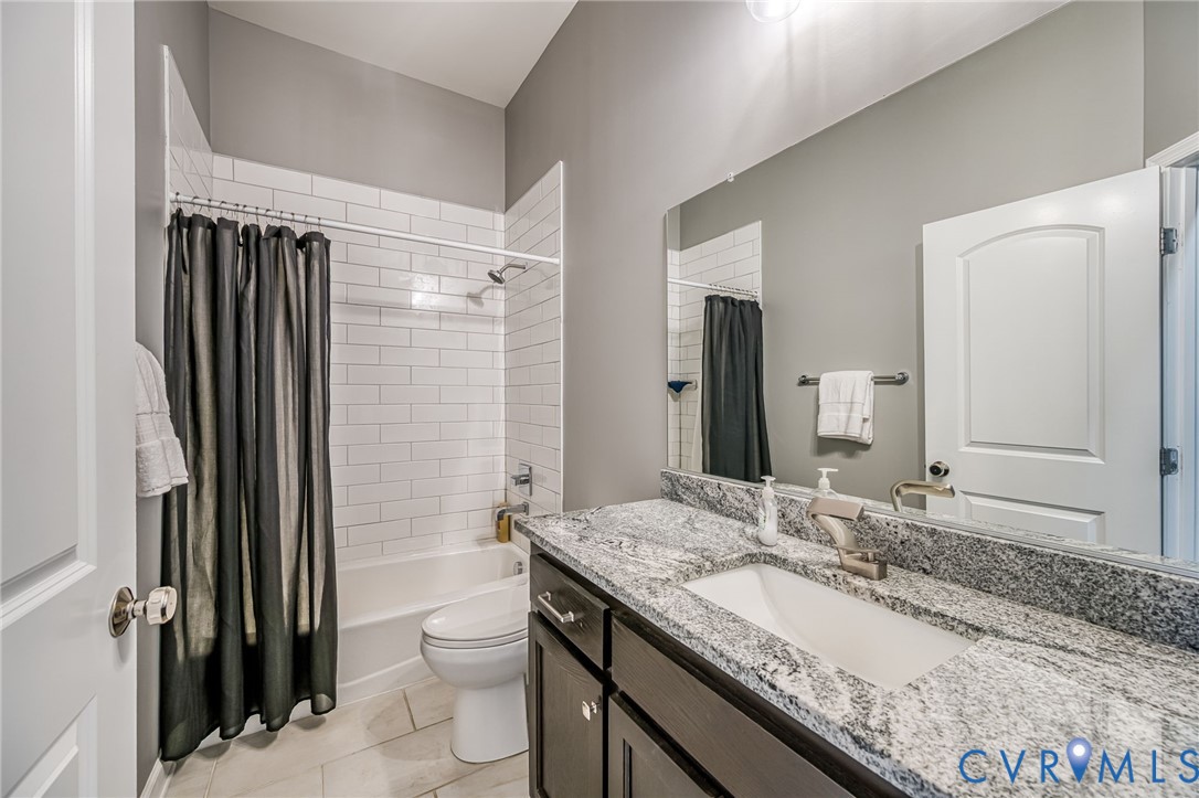 11534 Georgetown Road Mechanicsville, VA 23116 - Photo 18 of 37 a bathroom with a granite countertop sink toilet and shower