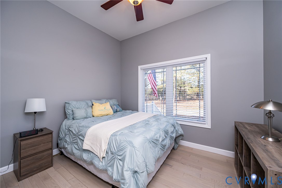 11534 Georgetown Road Mechanicsville, VA 23116 - Photo 24 of 37 a bedroom with a bed and a lamp on table