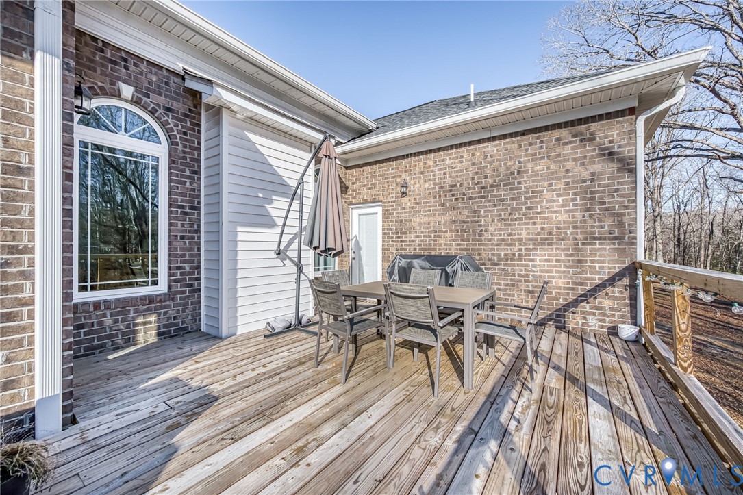 11534 Georgetown Road Mechanicsville, VA 23116 - Photo 34 of 37 a view of a patio with table and chairs with wooden floor