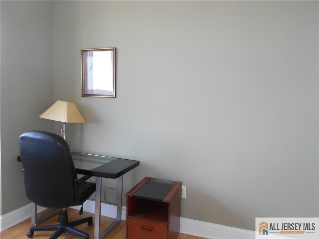1 Spring Street, Unit 2305 New Brunswick, NJ 08901 - Photo 14 of 29 a view of a workspace with furniture and a window