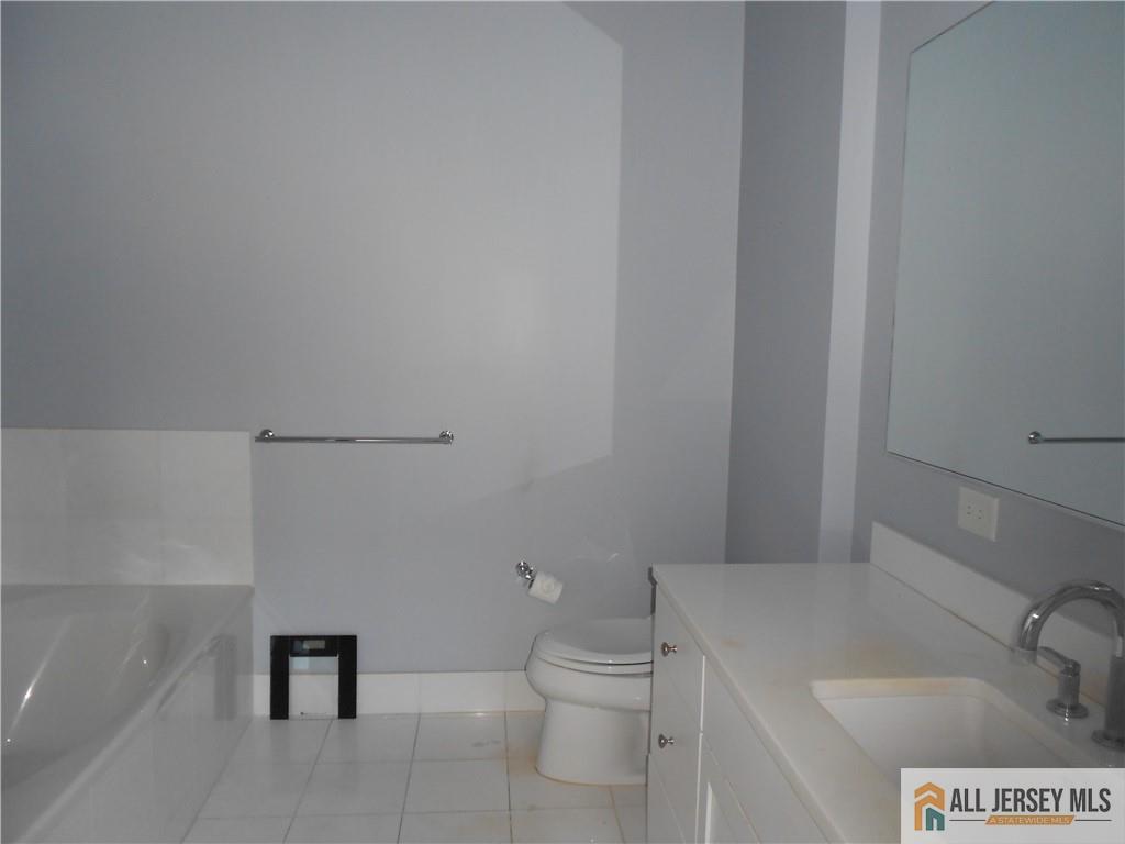 1 Spring Street, Unit 2305 New Brunswick, NJ 08901 - Photo 18 of 29 a bathroom with a toilet and a sink