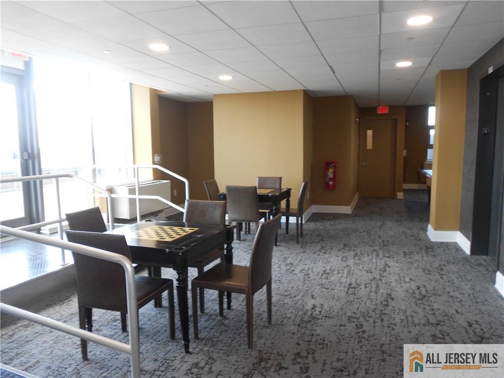 1 Spring Street, Unit 2305 New Brunswick, NJ 08901 - Photo 20 of 29 a dining room with furniture and window