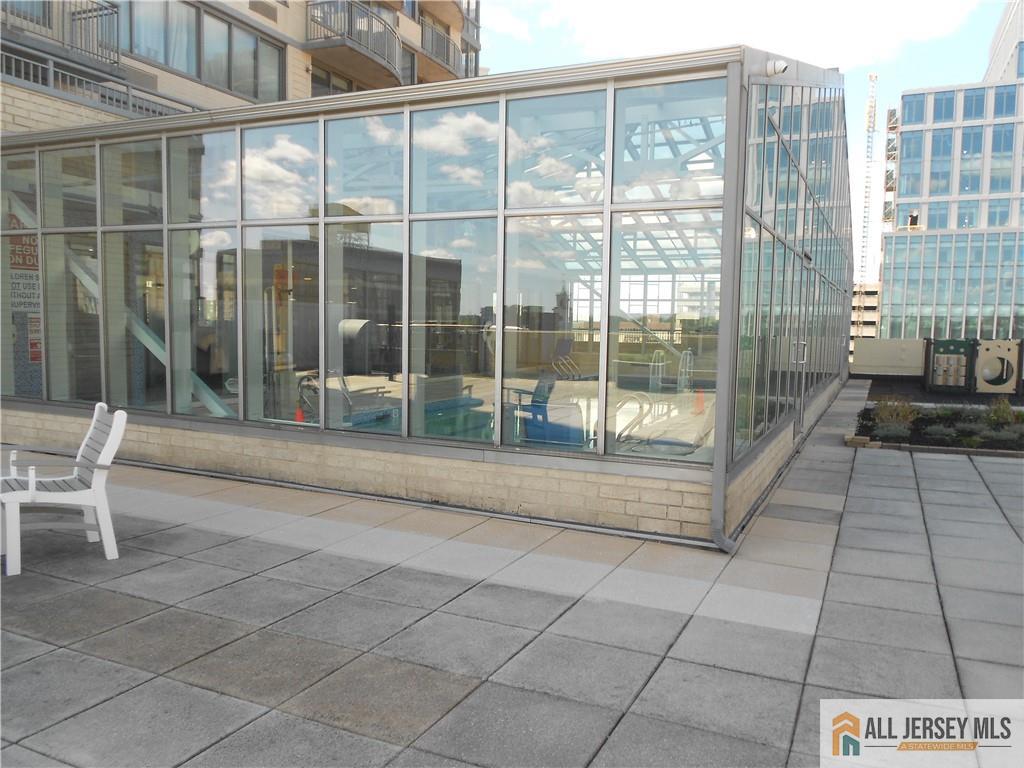 1 Spring Street, Unit 2305 New Brunswick, NJ 08901 - Photo 25 of 29 a view of a porch with a table and chairs