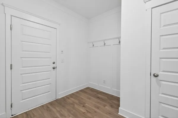 a view of a room with wooden floors and window