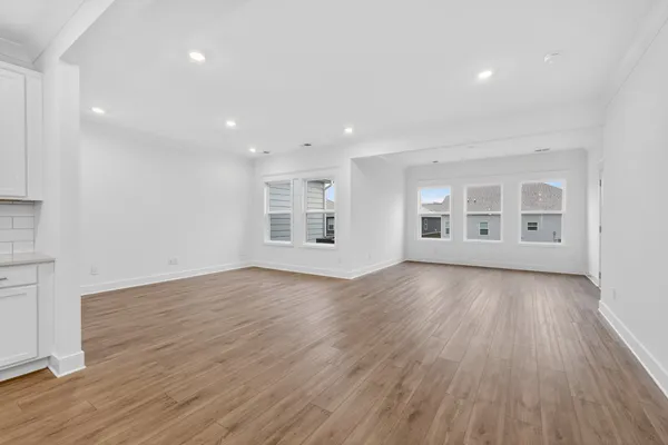 a view of a livingroom with wooden floor and window
