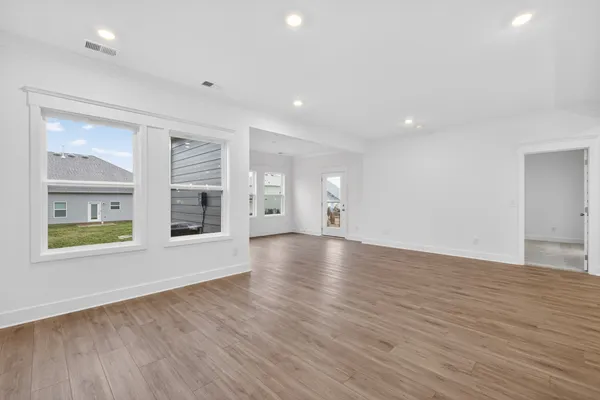 a view of a kitchen with a sink and wooden floor