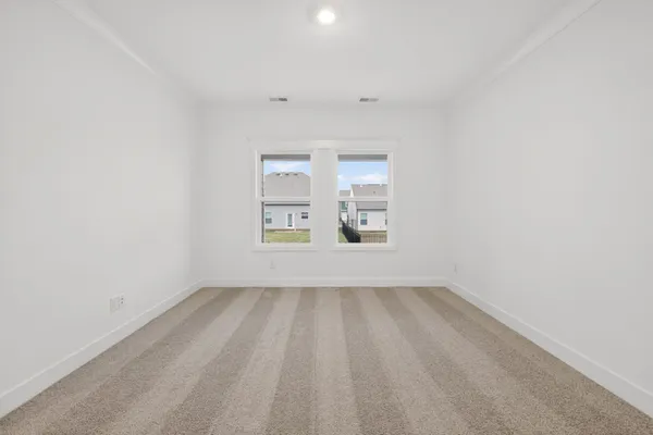 a view of an empty room and a bathroom