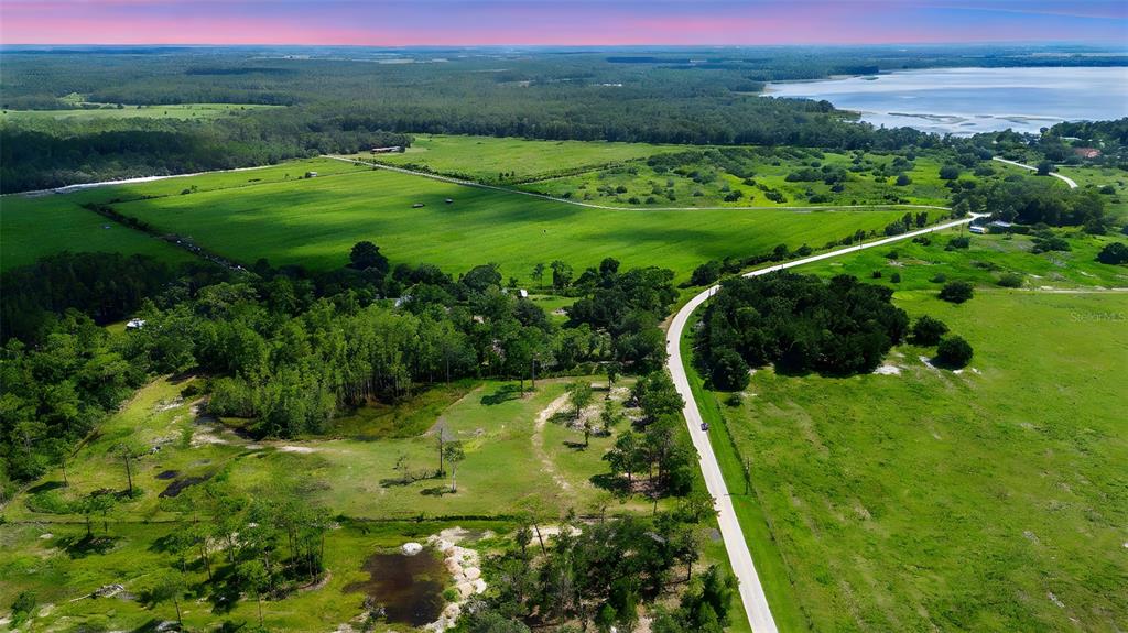 4365 Lake Gentry Road St. Cloud, FL 34772 - Photo 10 of 10 a view of a green yard with large trees