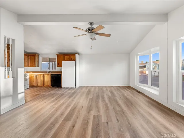 an empty room with windows and fireplace