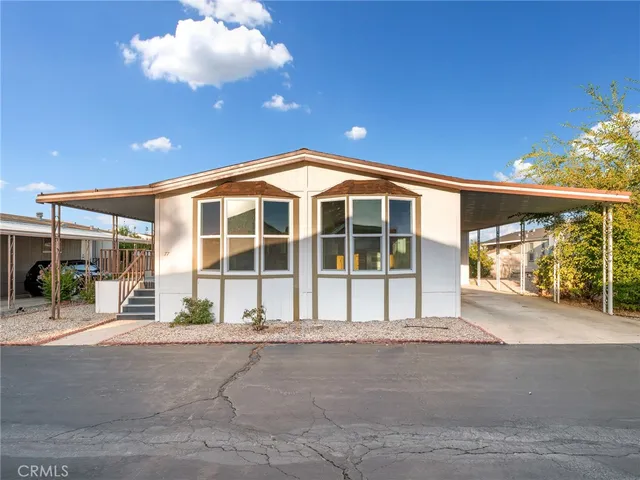 a view of a house with a backyard and a garage