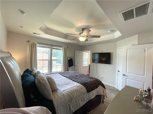 a bedroom with a large bed and a flat screen tv