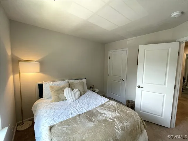 a bedroom with a bed and a mirror