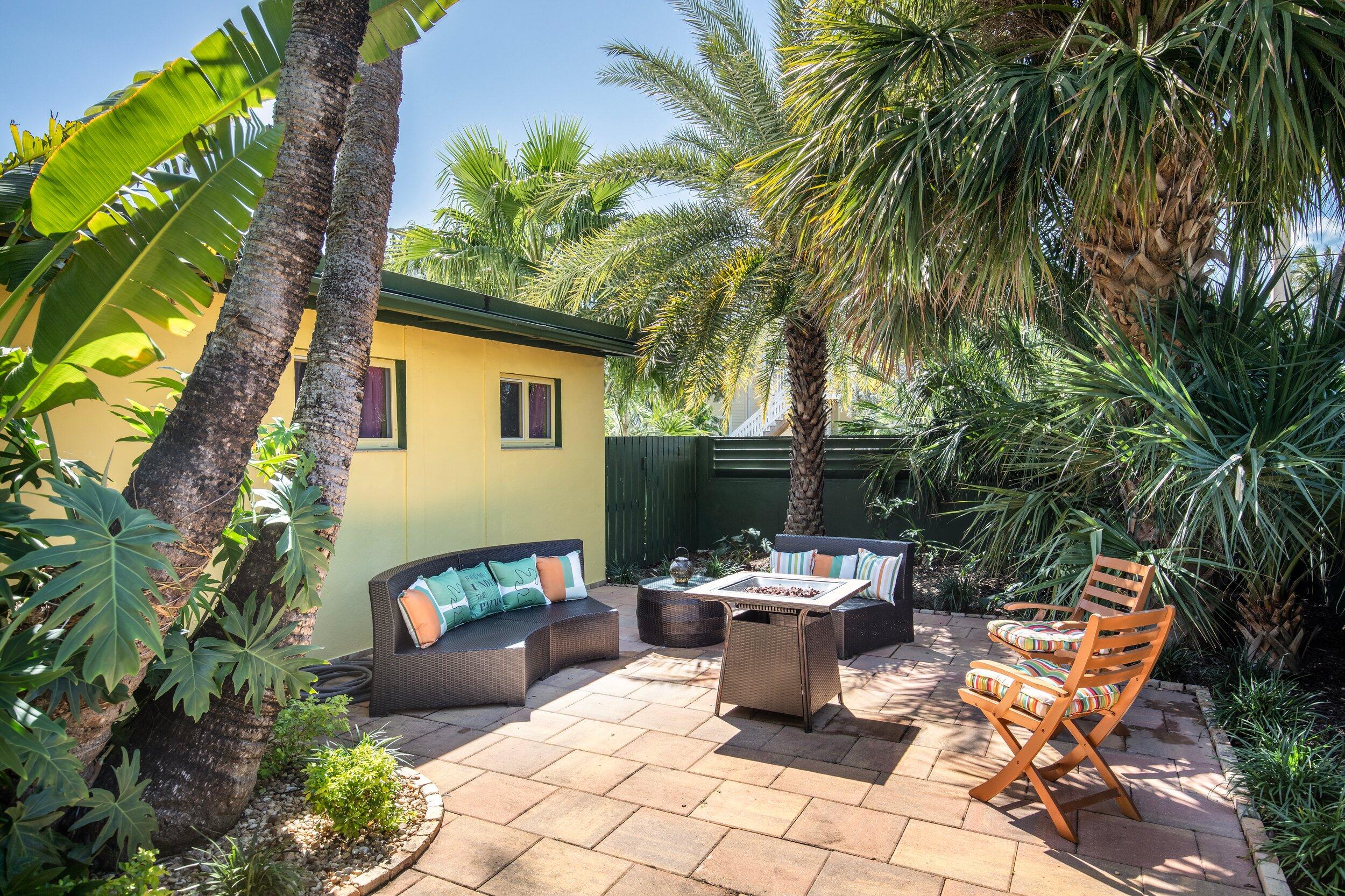 1519 Florida Street Key West, FL 33040 - Photo 67 of 86 a view of a patio with table and chairs potted plants and palm tree