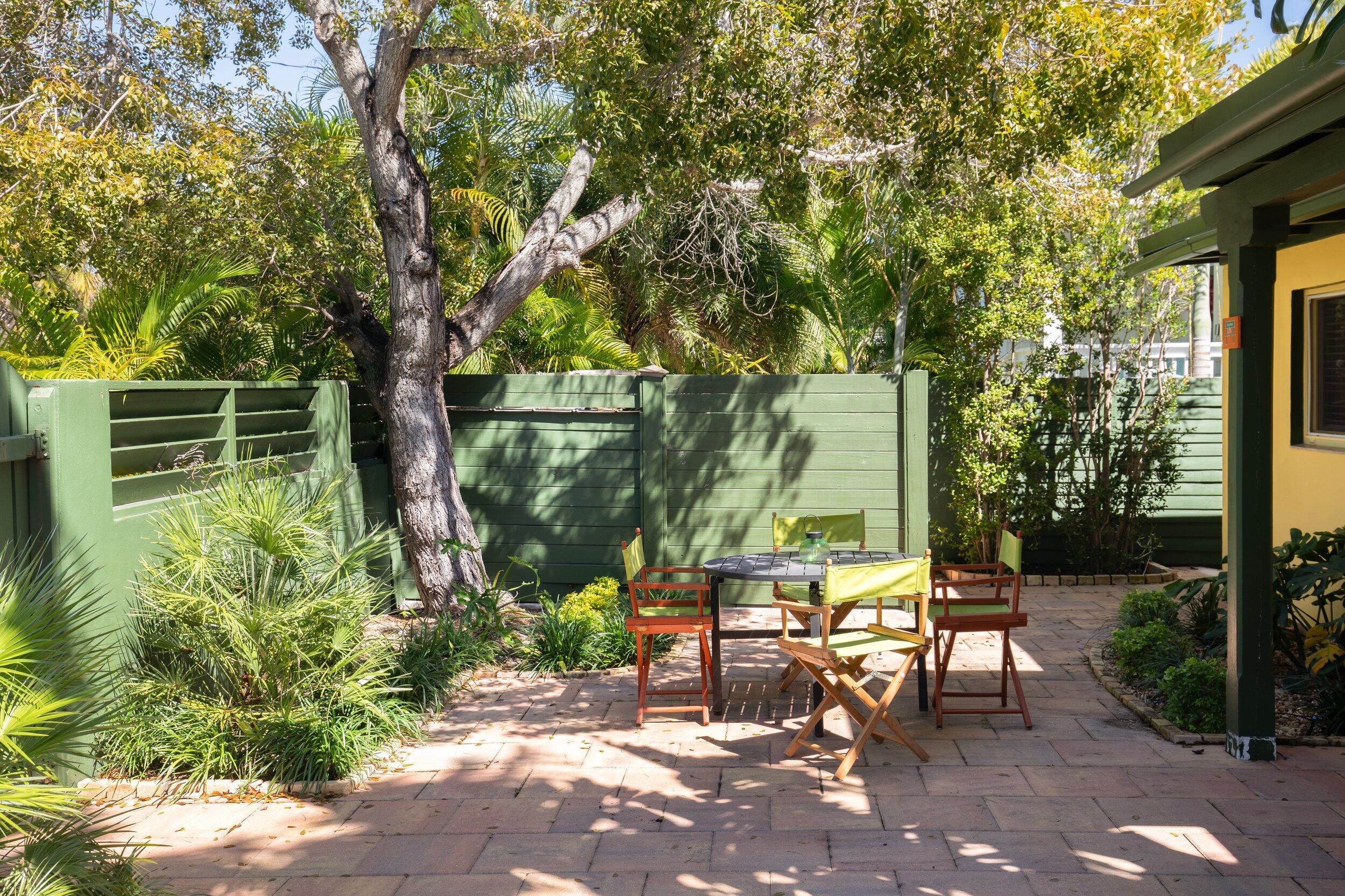 1519 Florida Street Key West, FL 33040 - Photo 68 of 86 a view of chair and tables in the patio next to a yard