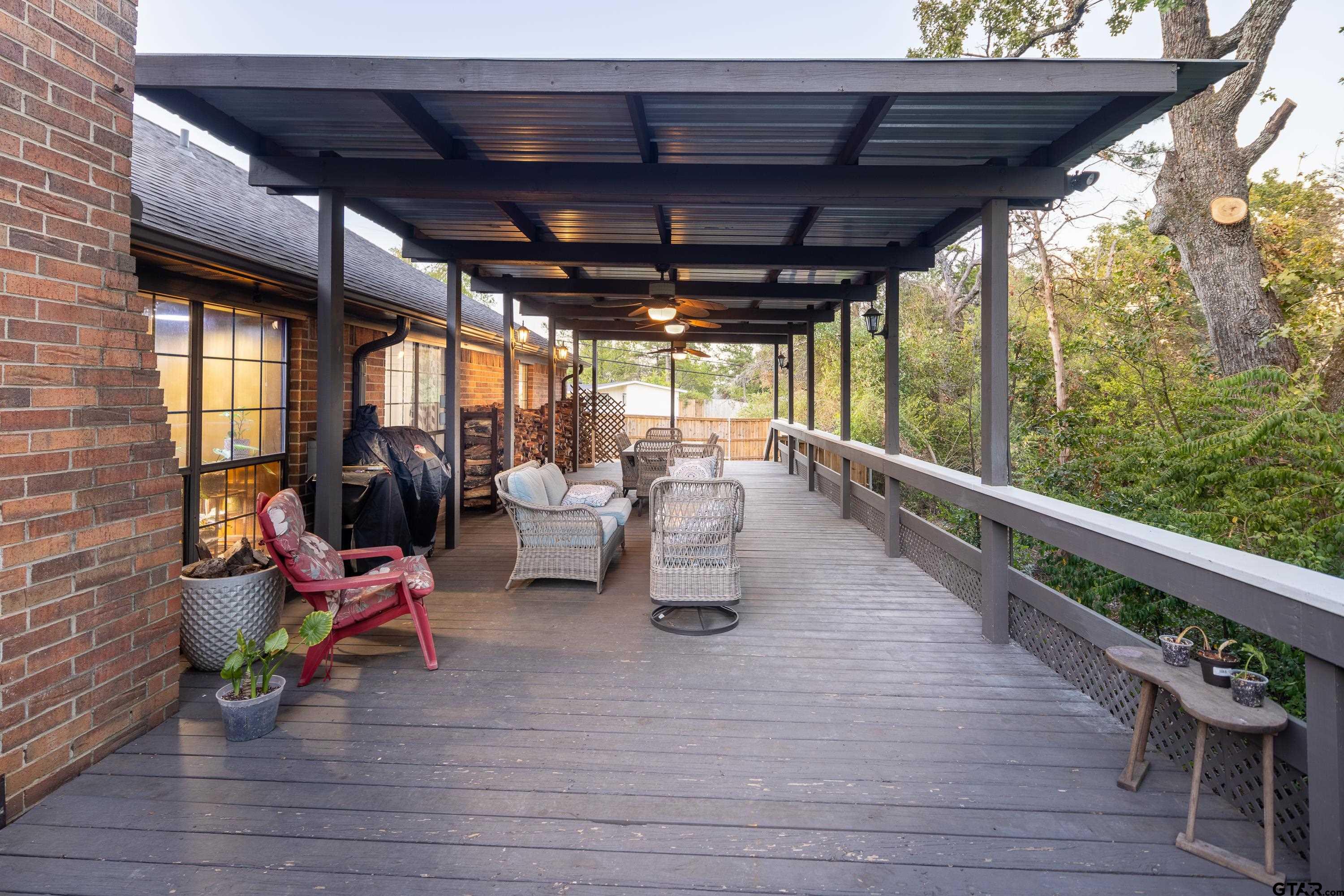 2900 West Azalea Drive Tyler, TX 75701 - Photo 1 of 37 a view of a patio with table and chairs