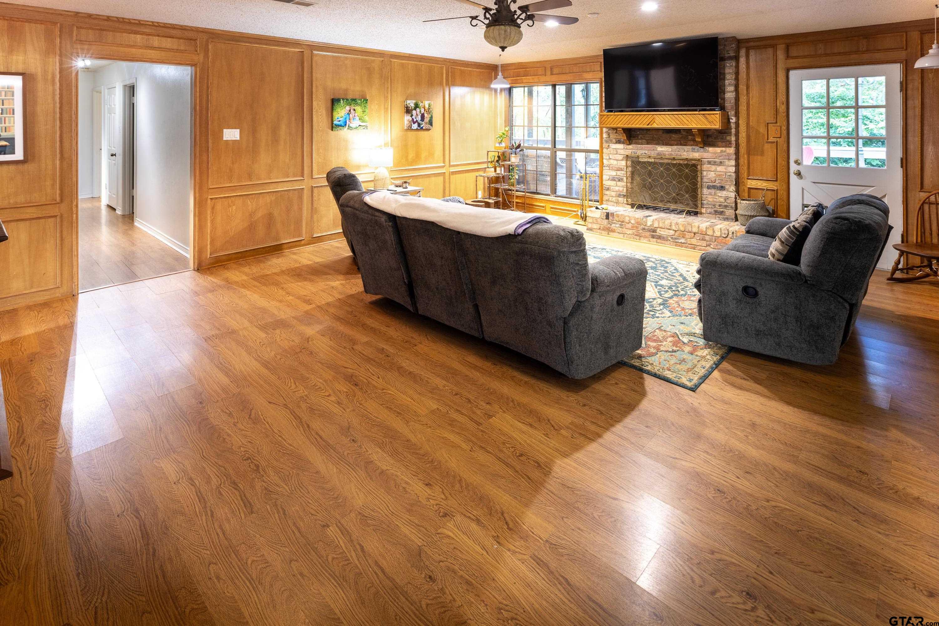 2900 West Azalea Drive Tyler, TX 75701 - Photo 12 of 37 a living room with furniture wooden floor and a fireplace
