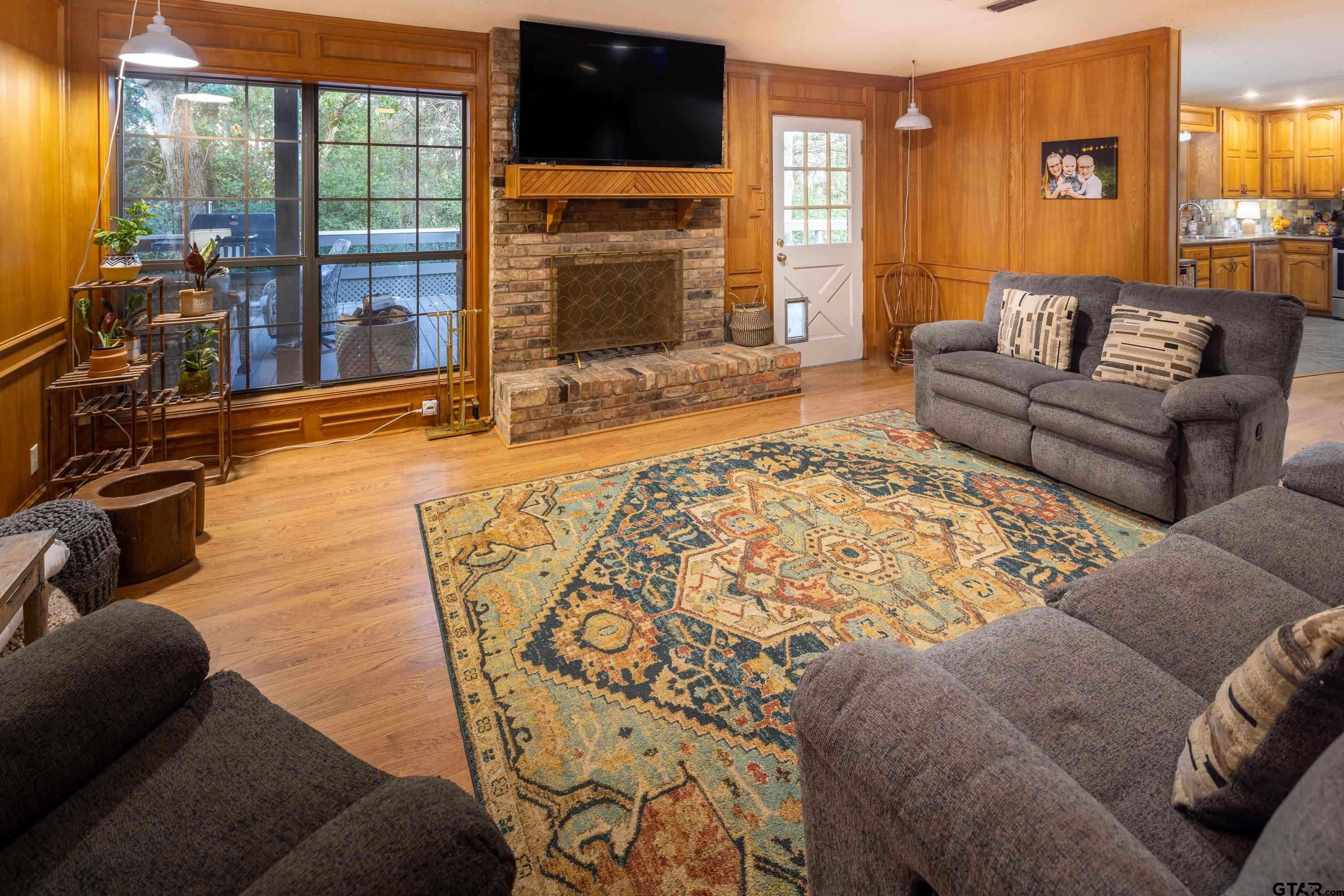 2900 West Azalea Drive Tyler, TX 75701 - Photo 15 of 37 a living room with fireplace furniture and a flat screen tv