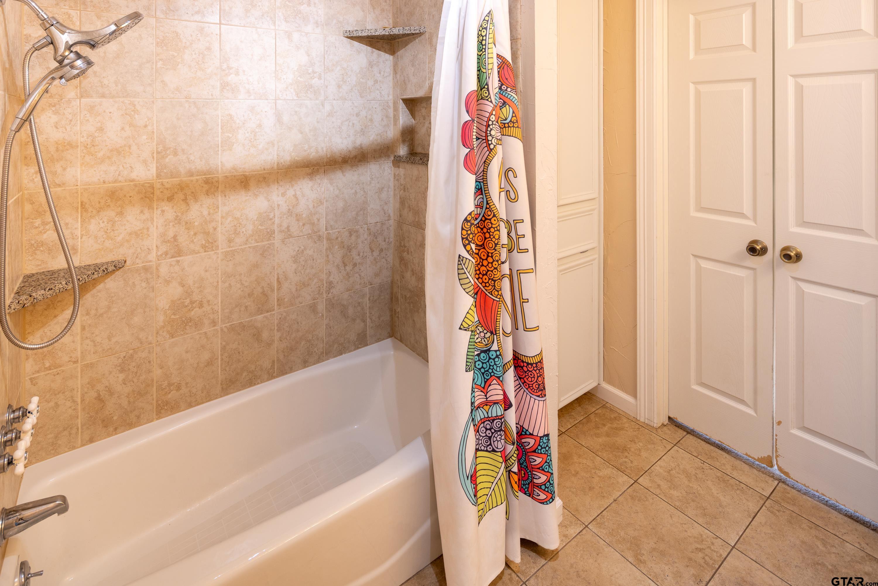 2900 West Azalea Drive Tyler, TX 75701 - Photo 18 of 37 a bathroom with a bathtub and shower