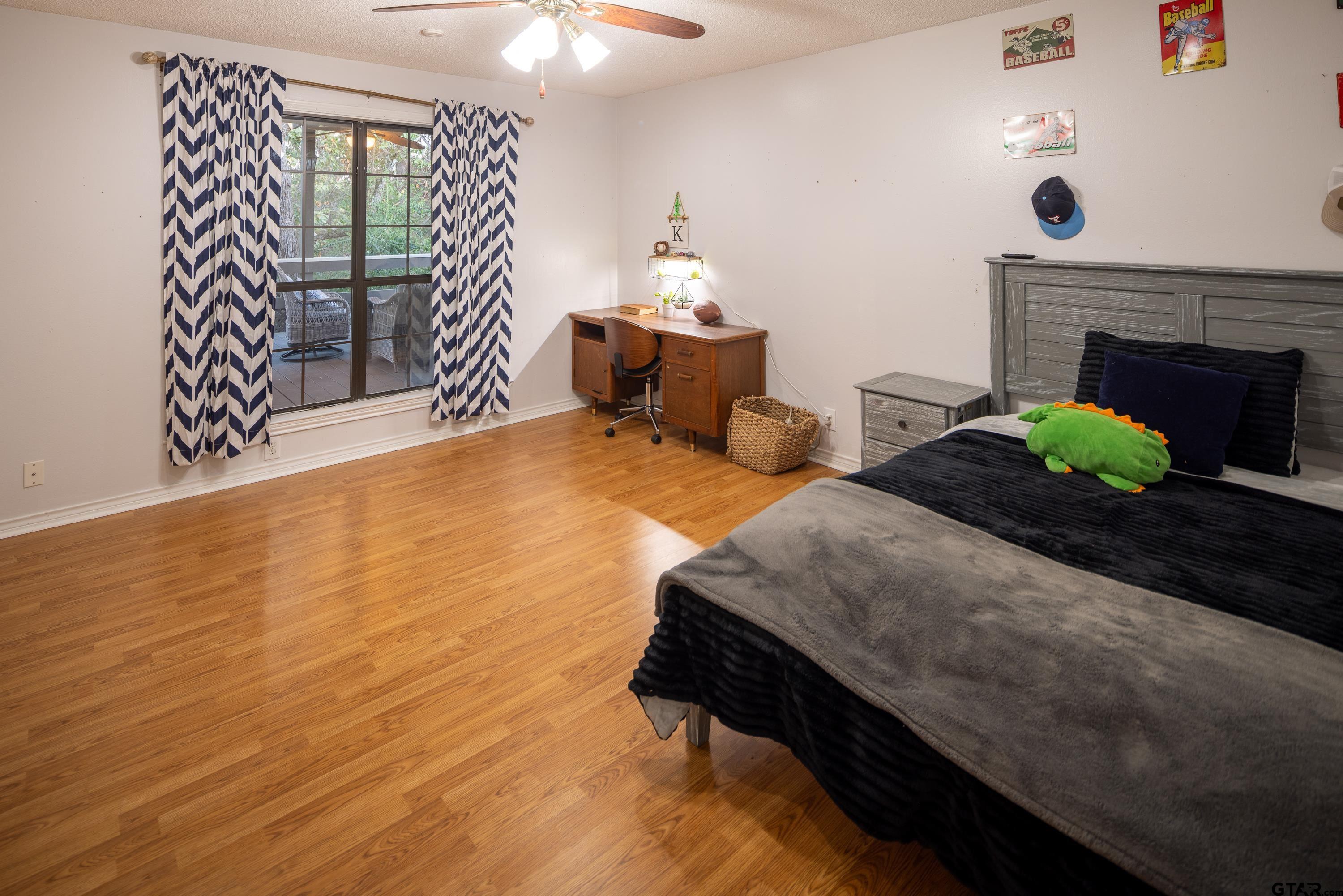 2900 West Azalea Drive Tyler, TX 75701 - Photo 20 of 37 a bedroom with a bed and a window