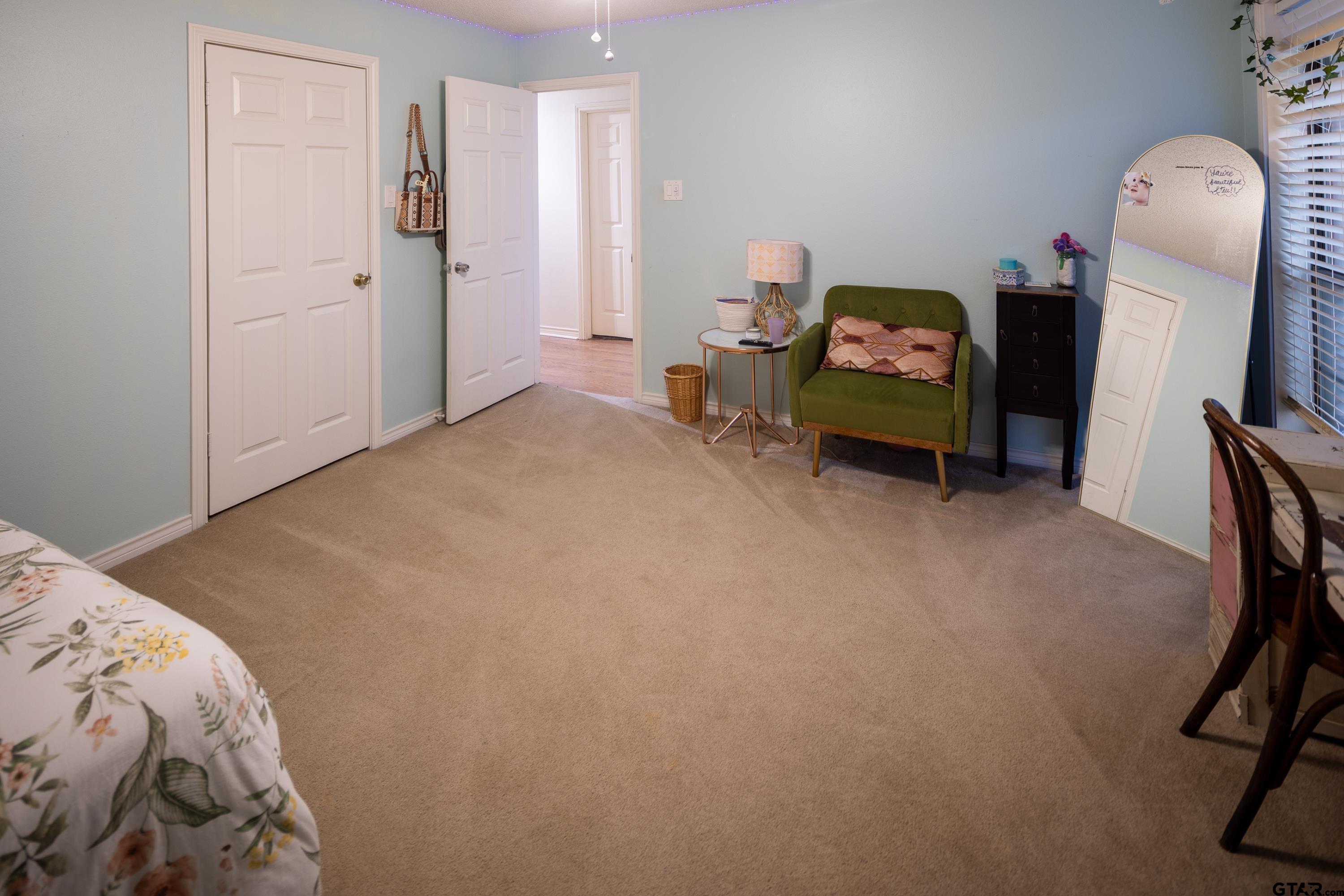 2900 West Azalea Drive Tyler, TX 75701 - Photo 21 of 37 a bed room with a bed and a chair