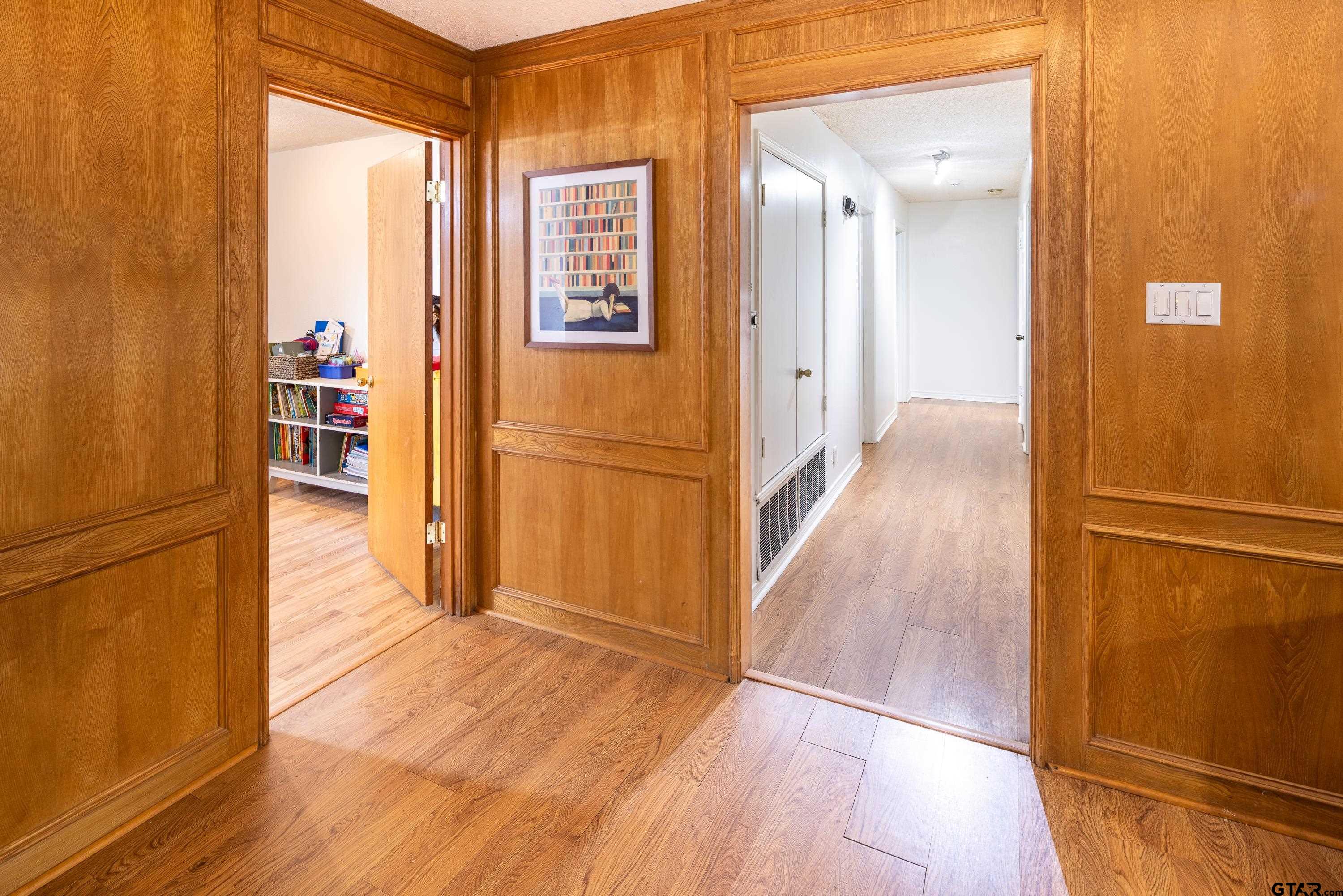 2900 West Azalea Drive Tyler, TX 75701 - Photo 24 of 37 a view of a hallway with wooden floor and staircase