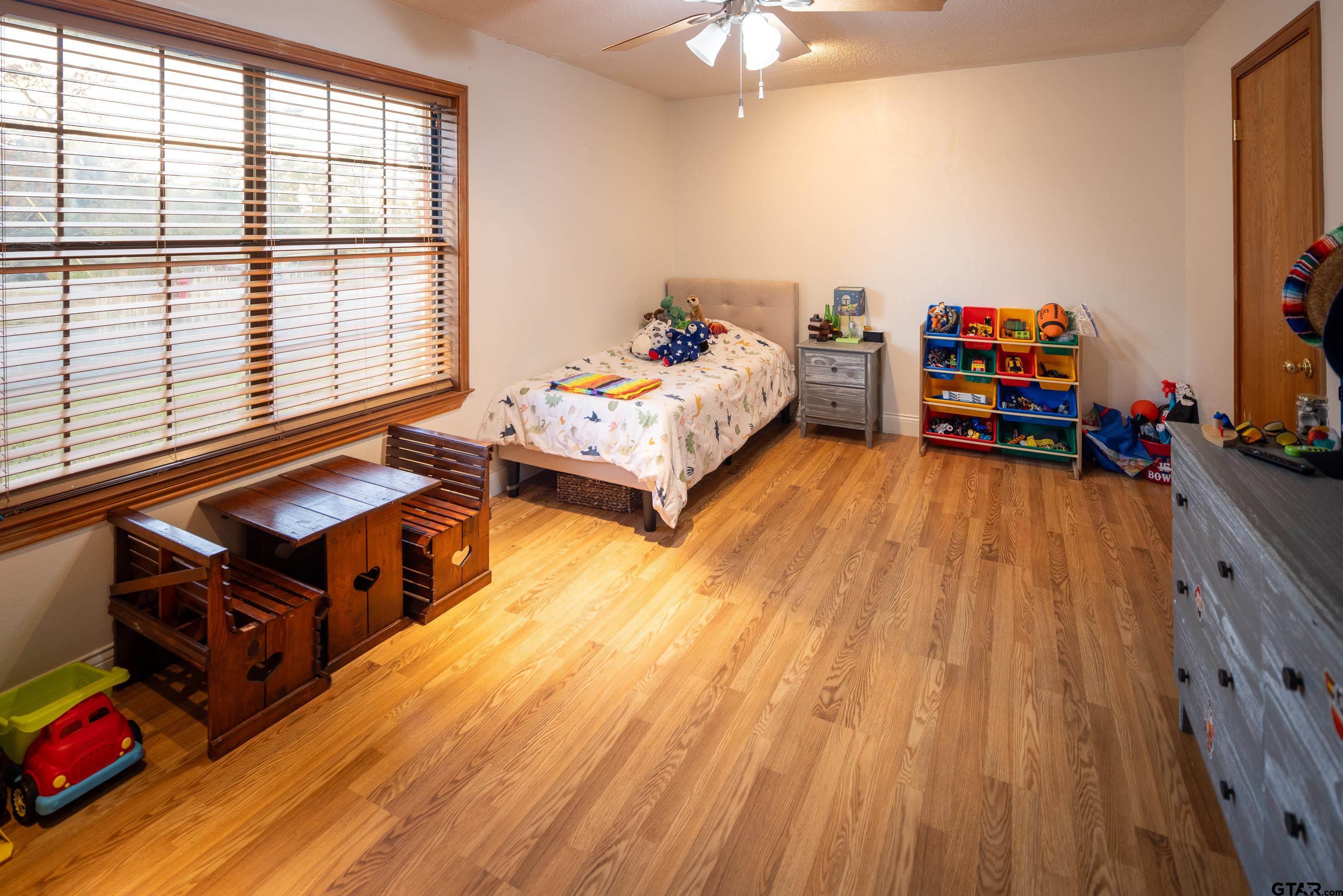 2900 West Azalea Drive Tyler, TX 75701 - Photo 25 of 37 a living room with furniture and a wooden floor