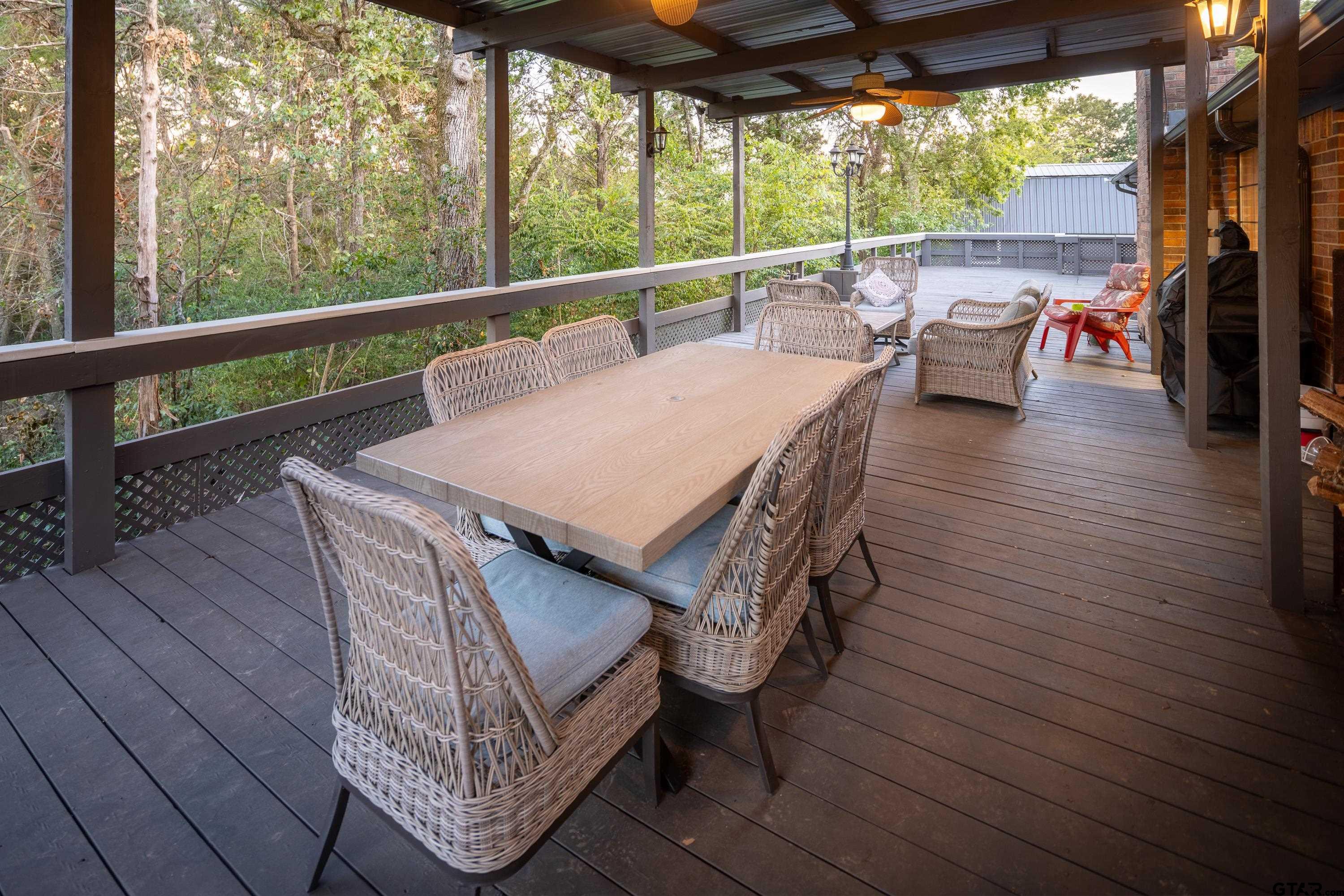 2900 West Azalea Drive Tyler, TX 75701 - Photo 30 of 37 a view of a patio with a table chairs and a patio