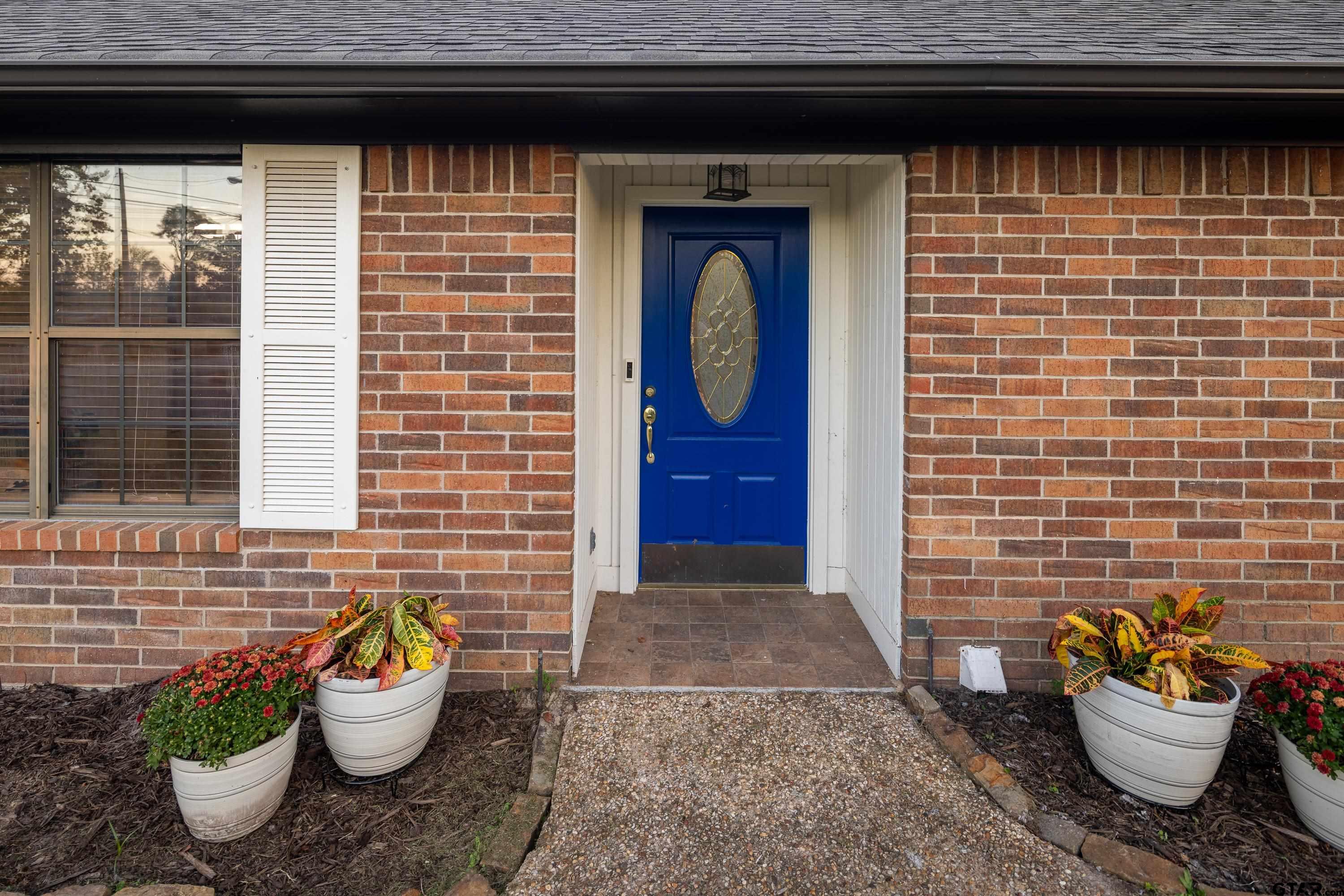 2900 West Azalea Drive Tyler, TX 75701 - Photo 3 of 37 a front view of a house with a potted plant