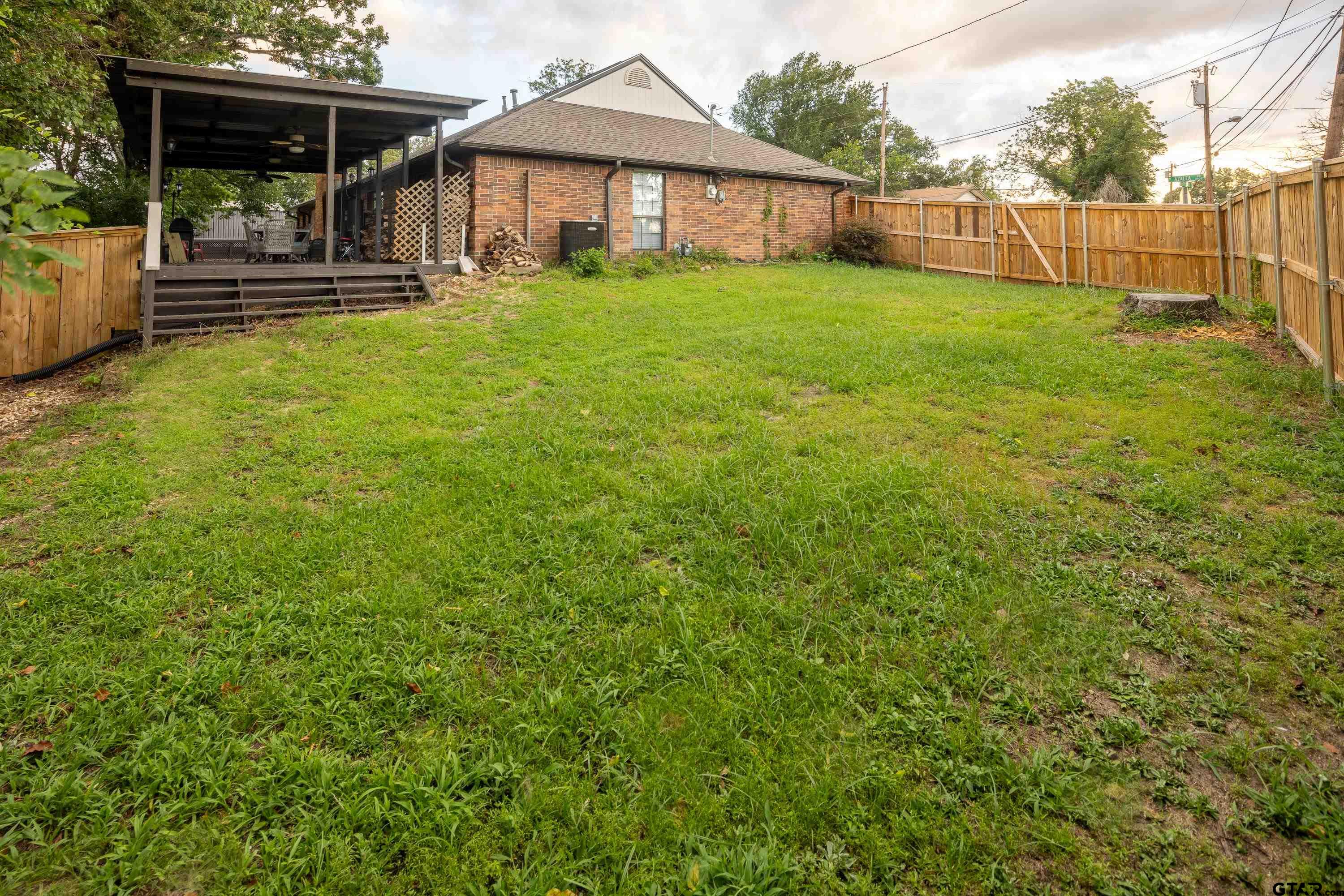 2900 West Azalea Drive Tyler, TX 75701 - Photo 33 of 37 a view of a house with backyard and porch