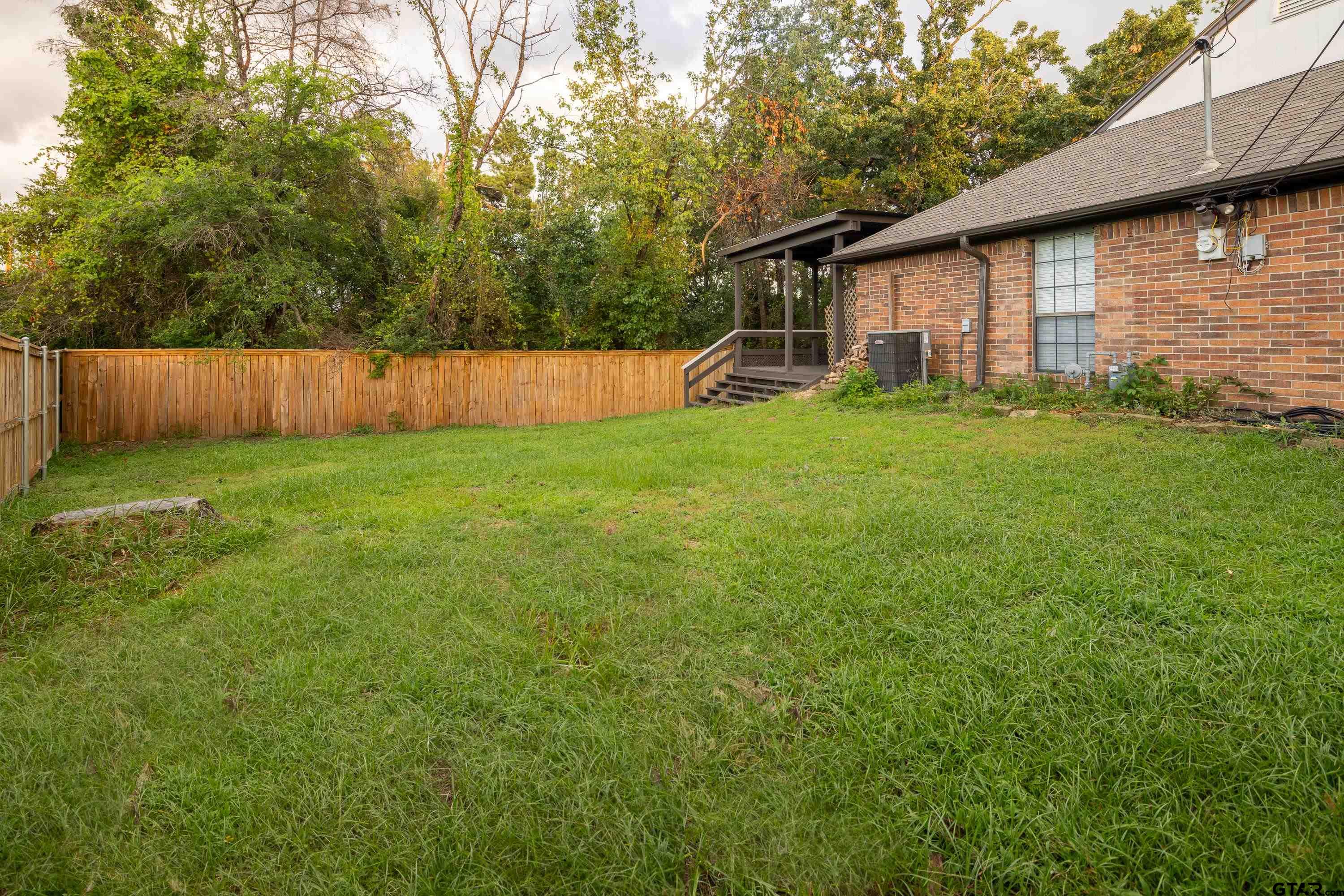 2900 West Azalea Drive Tyler, TX 75701 - Photo 34 of 37 a view of a backyard with a garden