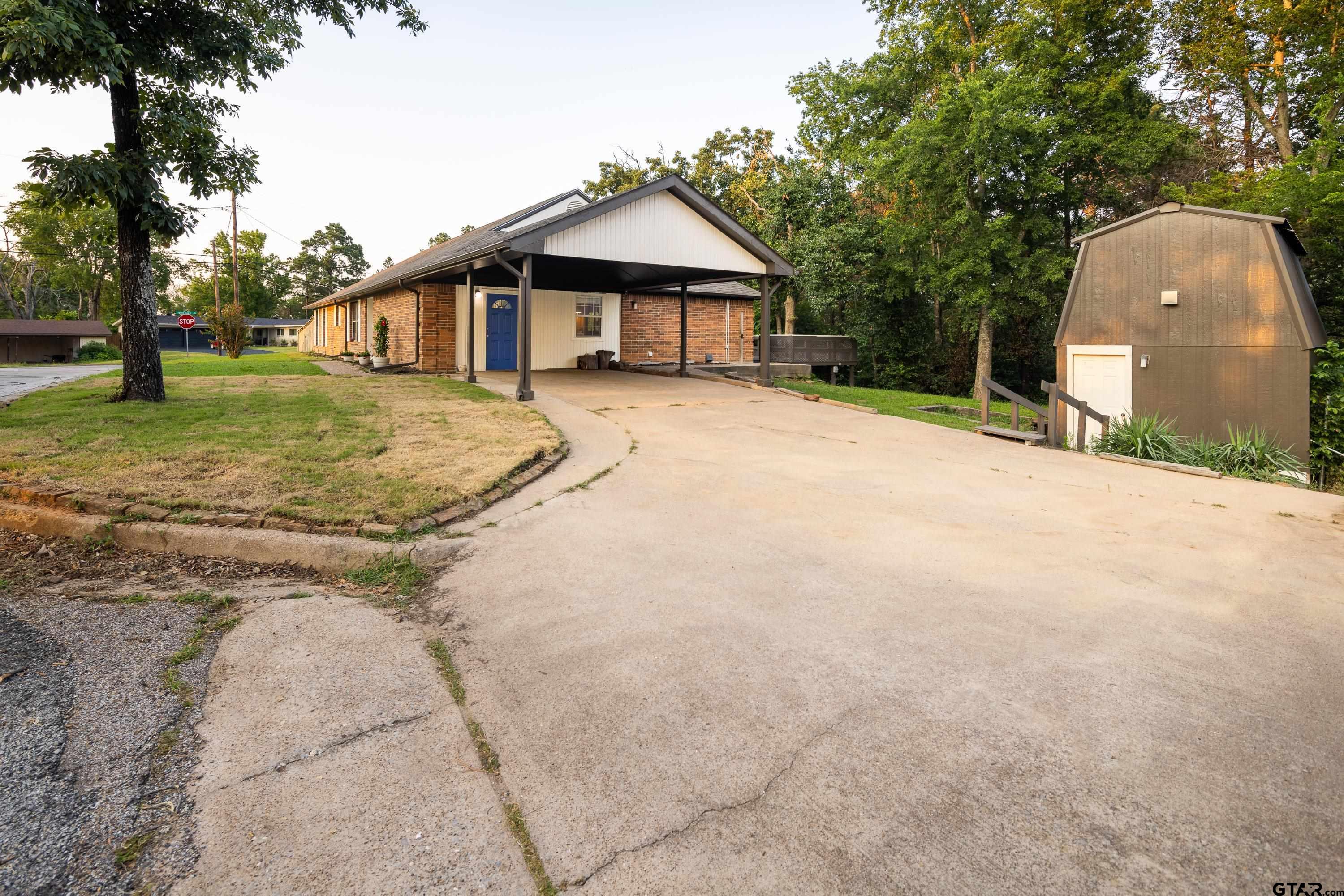 2900 West Azalea Drive Tyler, TX 75701 - Photo 35 of 37 a front view of a house with a yard