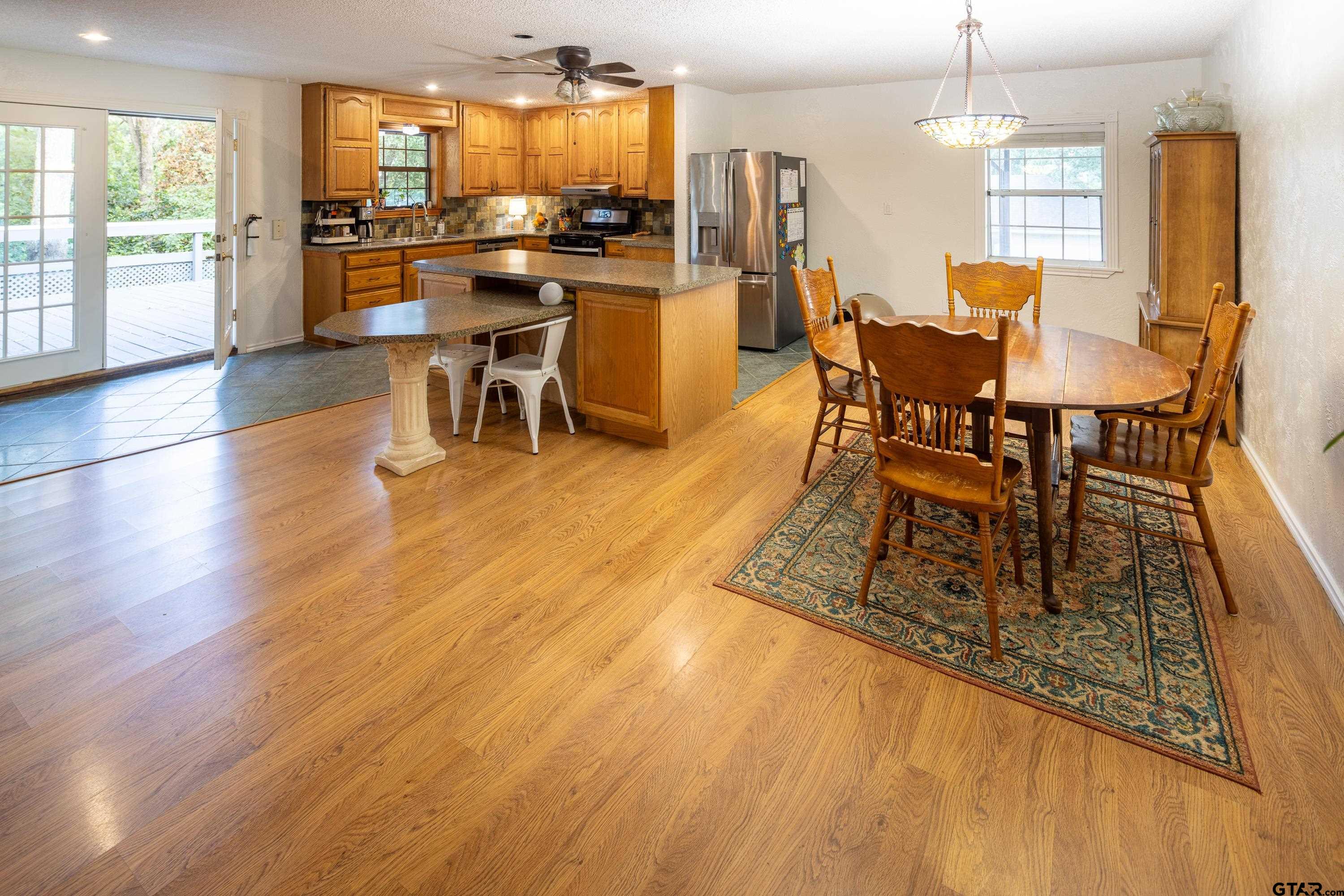 2900 West Azalea Drive Tyler, TX 75701 - Photo 6 of 37 a dining room with furniture a chandelier and wooden floor