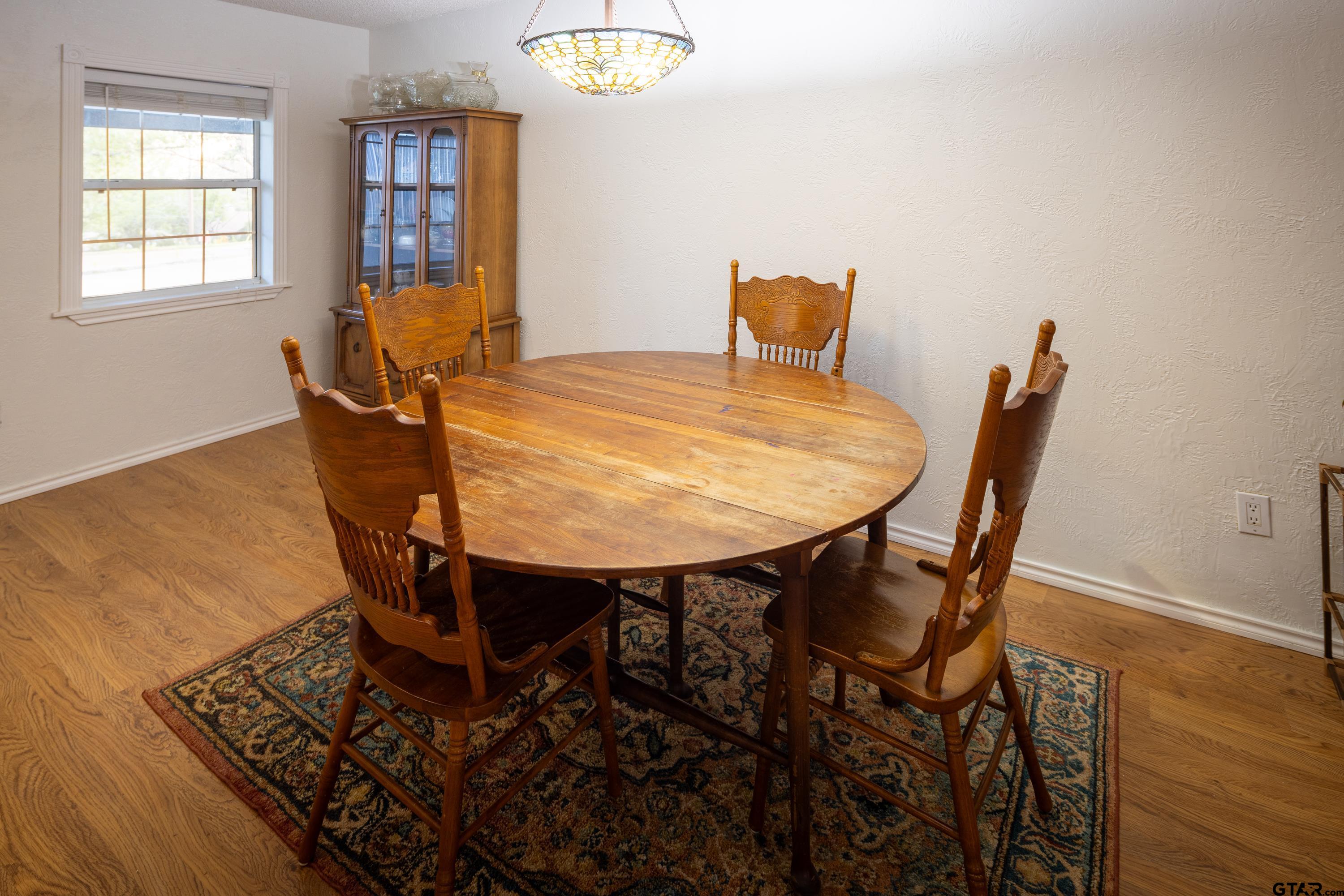 2900 West Azalea Drive Tyler, TX 75701 - Photo 10 of 37 a view of a dining room with furniture and wooden floor