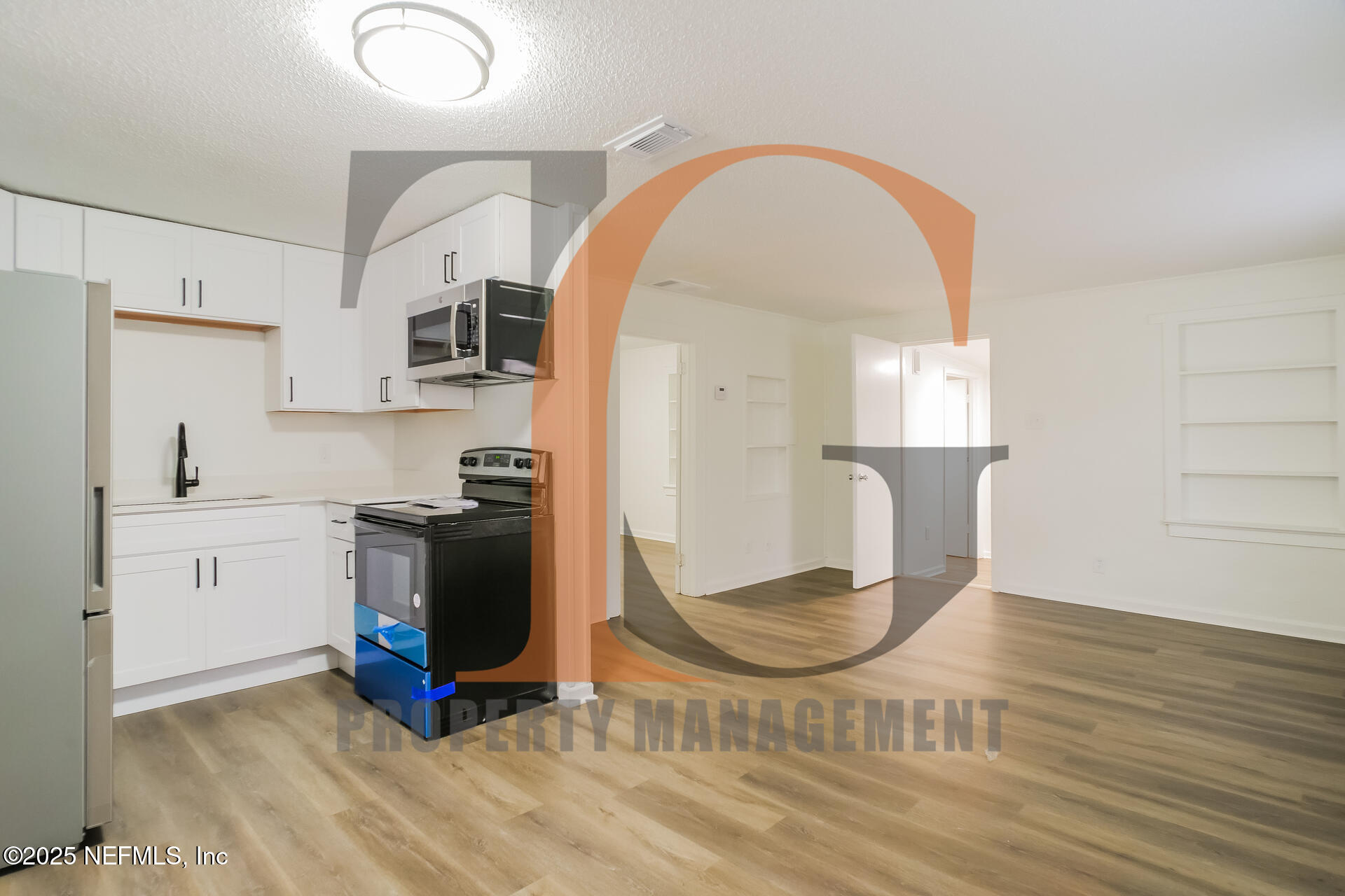 113 Cedar Street St. Augustine, FL 32084 - Photo 3 of 10 a kitchen with stainless steel appliances granite countertop a stove a sink dishwasher and a refrigerator with wooden floor