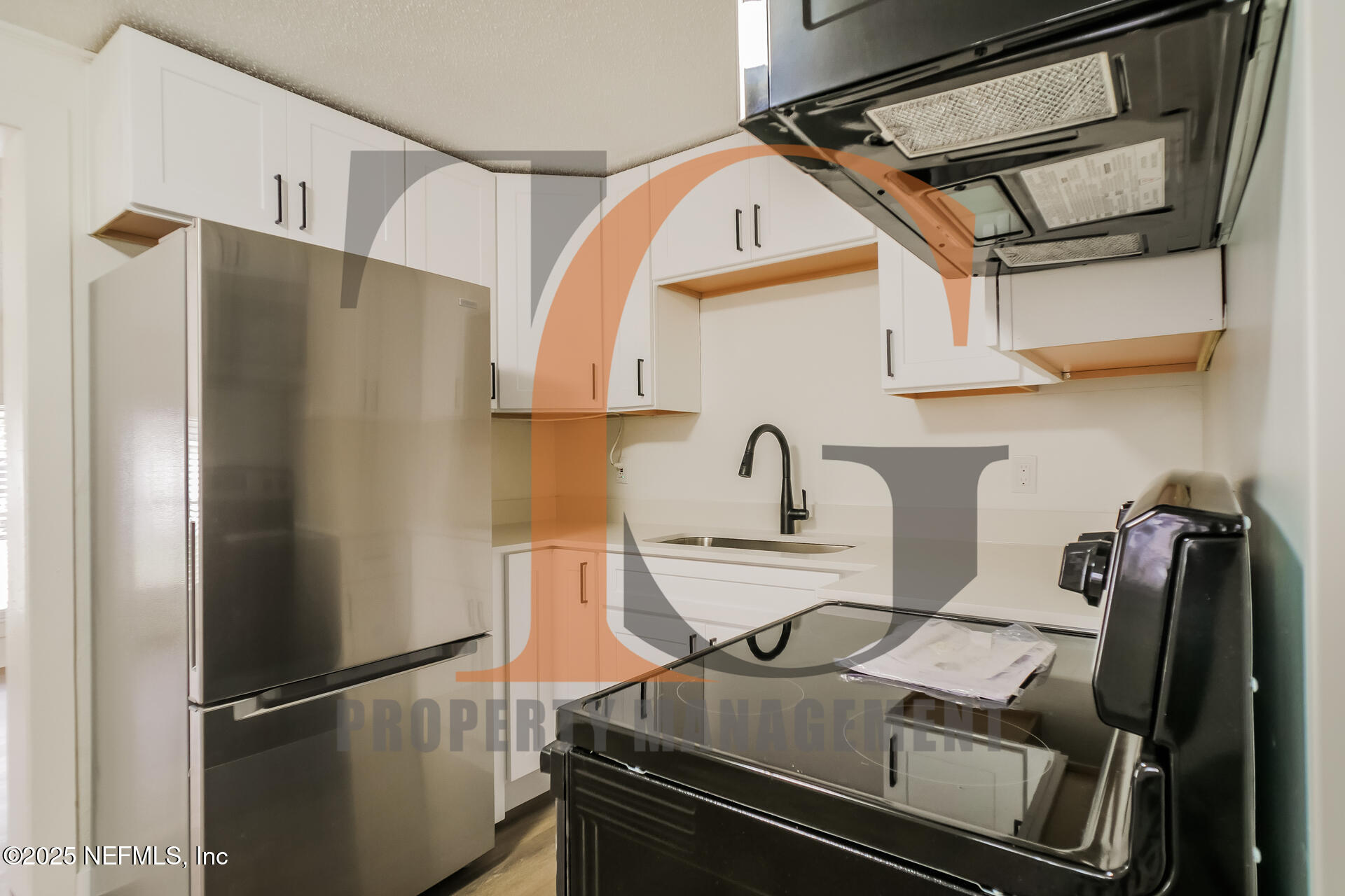 113 Cedar Street St. Augustine, FL 32084 - Photo 4 of 10 a kitchen with stainless steel appliances granite countertop a refrigerator and a stove