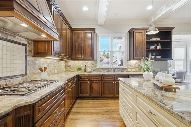 a kitchen with stainless steel appliances granite countertop a refrigerator and a sink