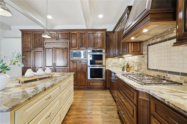 a kitchen with granite countertop a sink cabinets and wooden floor