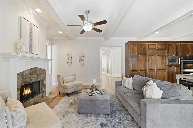 a bedroom with a bed a chandelier and a dresser