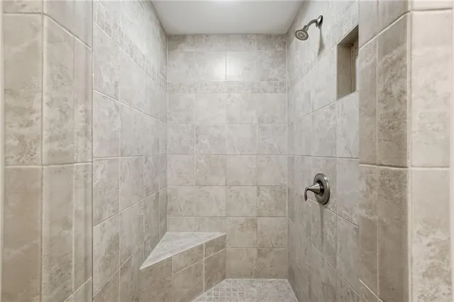 a bathroom with a granite countertop toilet a sink and a mirror