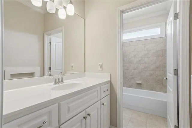 a view of an empty room and kitchen with wooden floor