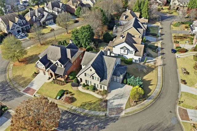 an aerial view of a house with a yard