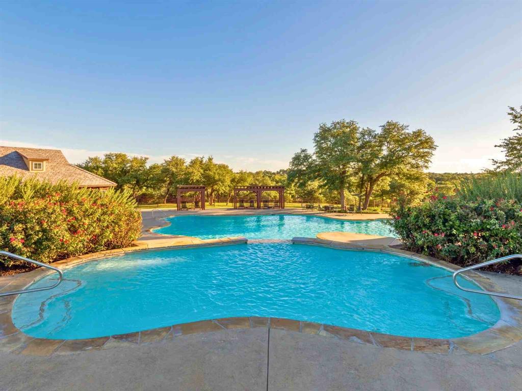 8452 Carnegie Street Cleburne, TX 76033 - Photo 10 of 12 a view of a swimming pool with an outdoor seating and a yard