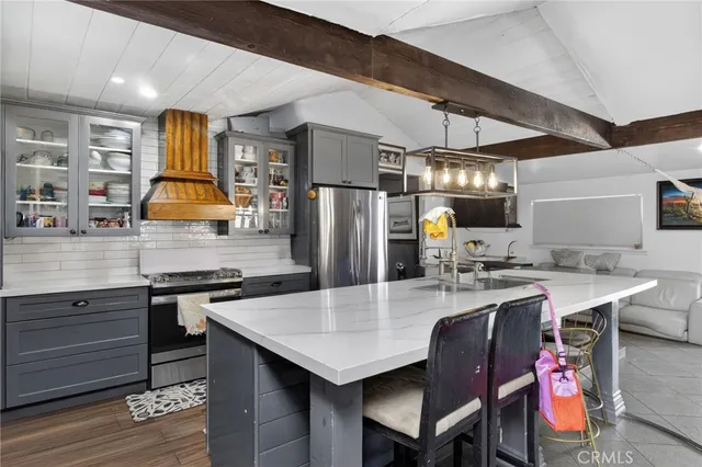 a kitchen with a stove a refrigerator and a dining table